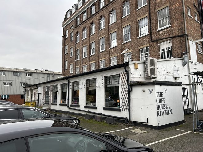 The low white cafe unit seen from the car park