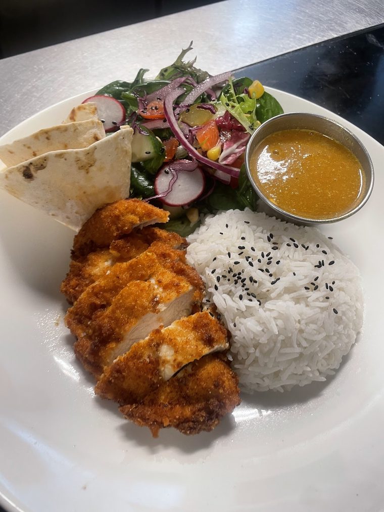 Chicken katsu curry with rice and salad, shot from above